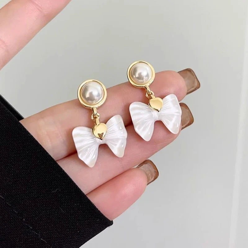 Elegant Pearl Bow Drop Earrings – Gold-Plated Heart Accent Dangle Earrings